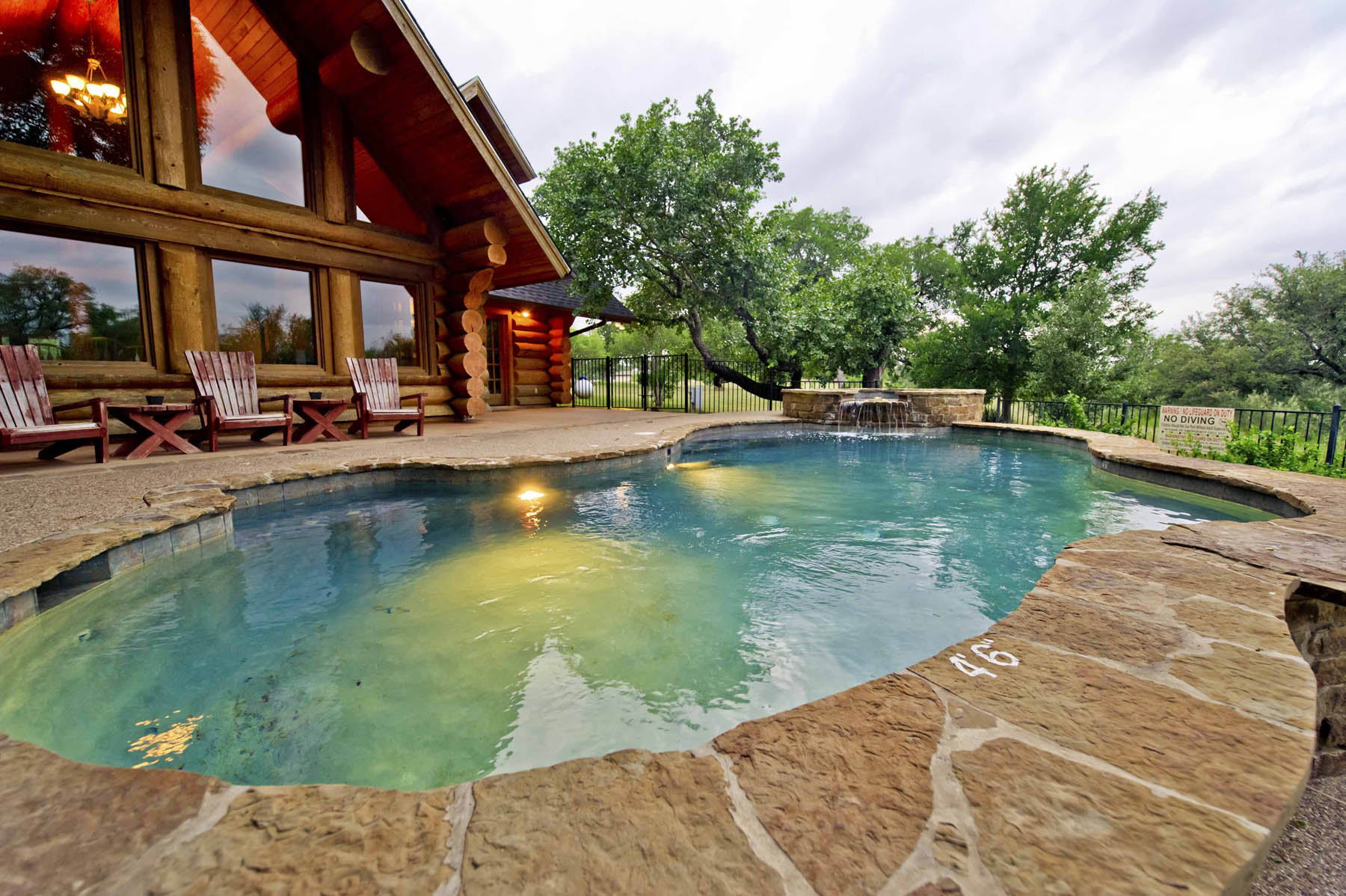 Cabin exterior, outdoor pool, hot tub.